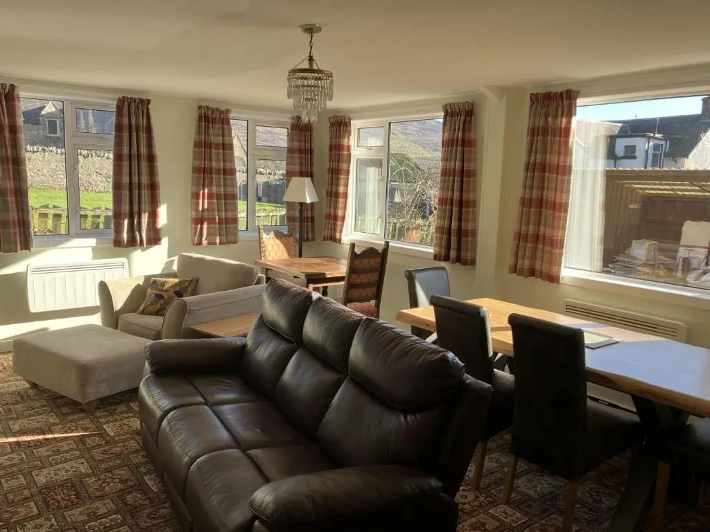 a living room with a couch and a table at Crianlarich Cottage in Fort Augustus