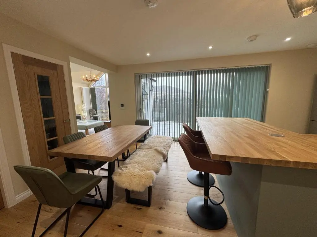 a dining room with two wooden tables and chairs at Sunny Ridge in Fort Augustus