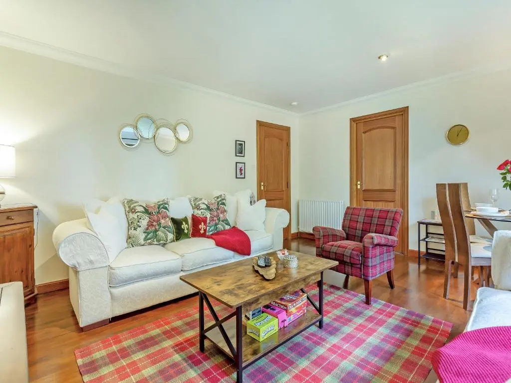 a living room with a couch and a table at Cosy Ness in Inverness