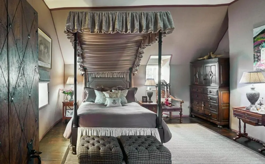 a bedroom with a four poster bed with a canopy at The Fortalice in Tulchan