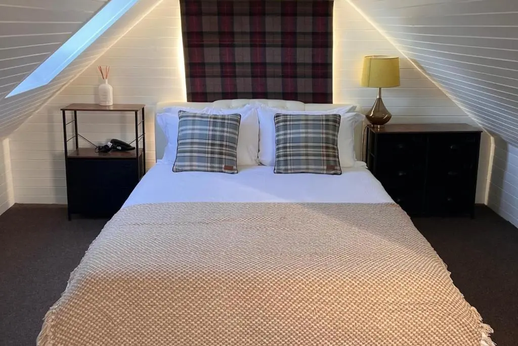 a bedroom with a bed with two pillows at Pets - Garden - Parking - Sleeps 2 - Hiking in Banchory