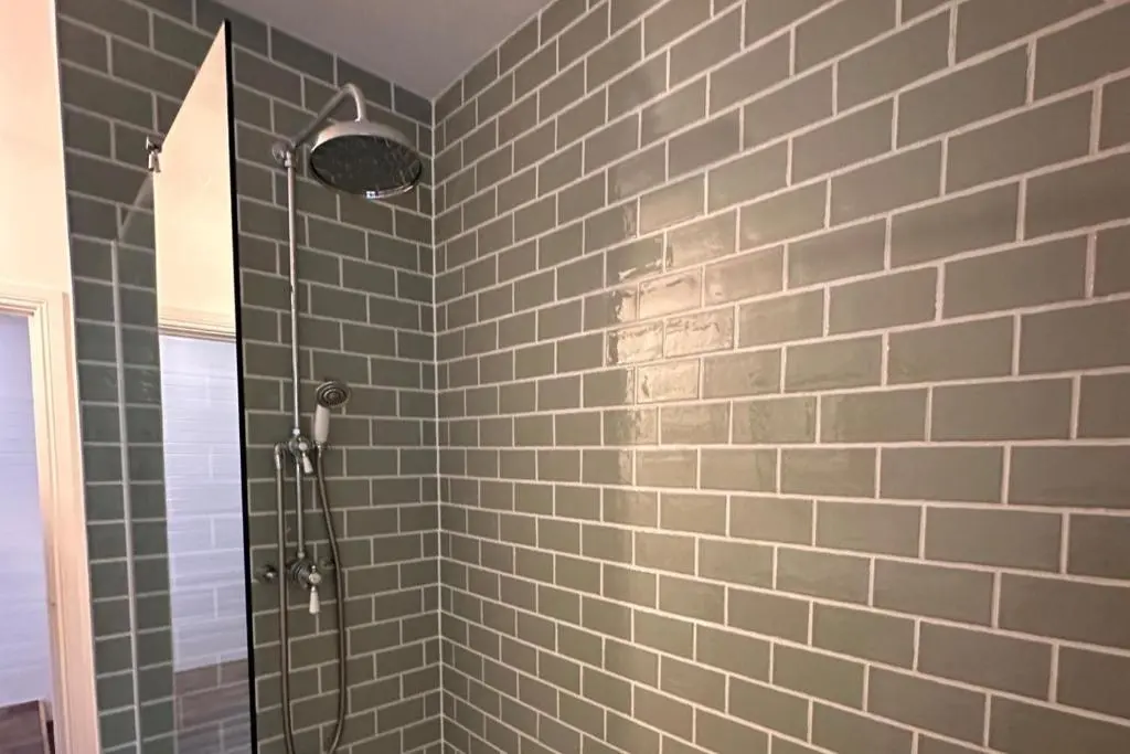 a bathroom with a shower with gray tiles at Pets - Garden - Parking - Sleeps 2 - Hiking in Banchory