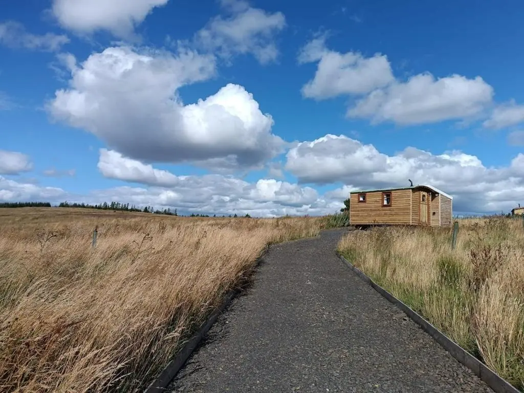 a small house in the middle of a field at The Rumster Hut in Lybster