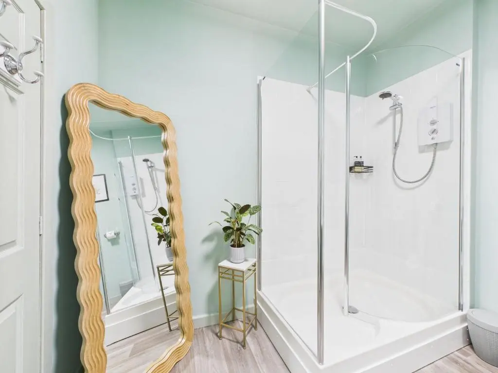 a bathroom with a shower and a mirror at Glenshee Suite, Beechtree Cottage in Kirkmichael