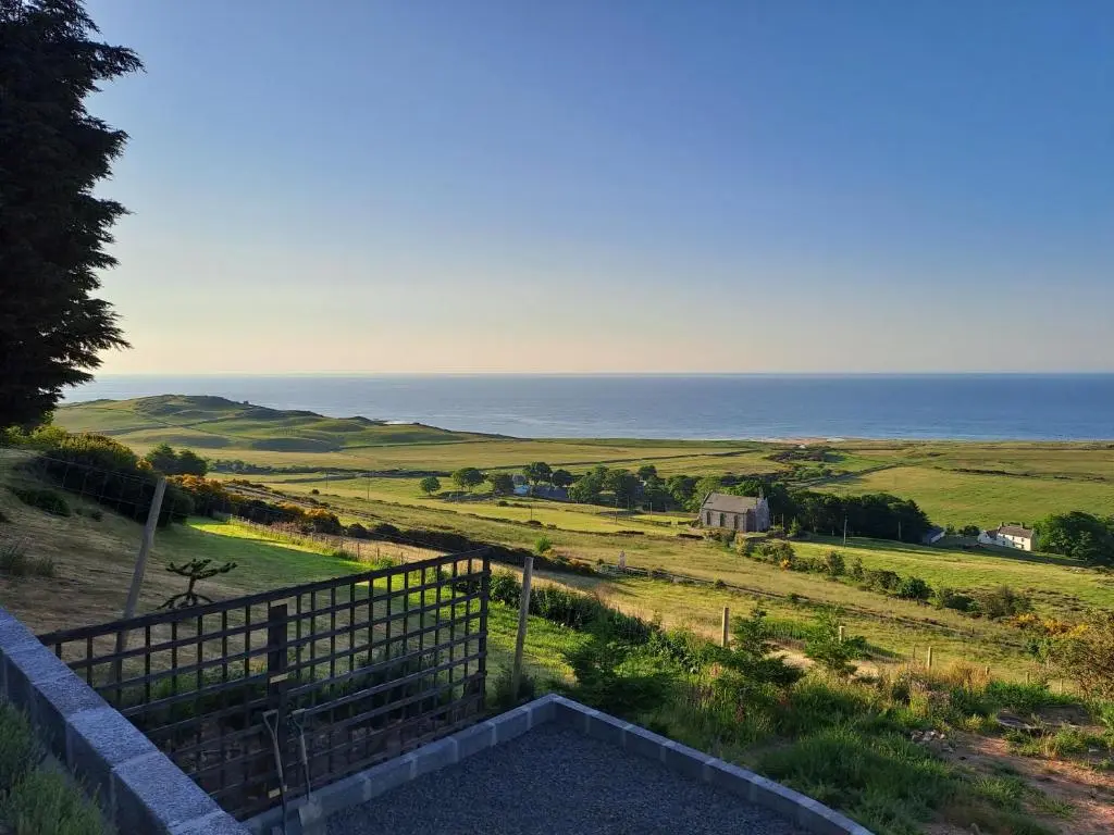 a view of the ocean from the balcony of a house at Lothmore Lookout - Sunrise in Kilmote