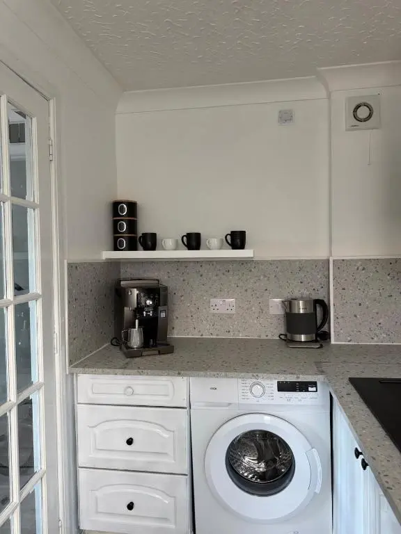 a kitchen with a washing machine in a kitchen at Nessy5 Apartment in Inverness