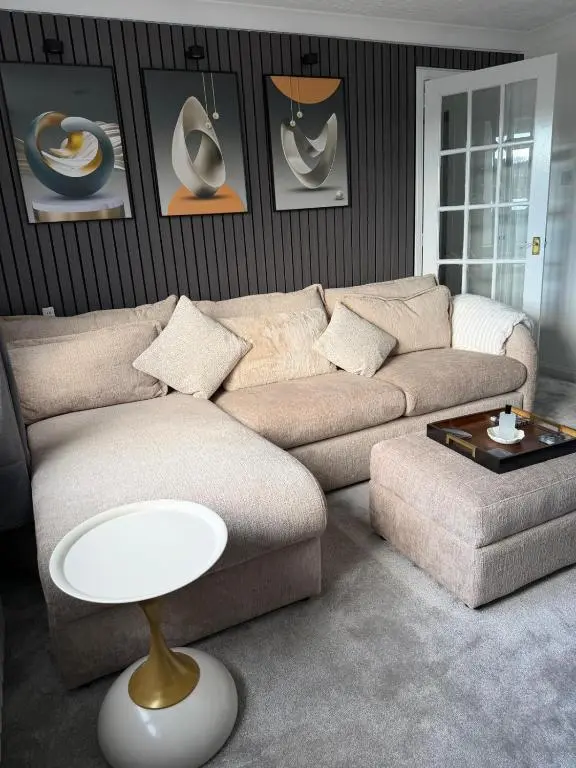 a living room with a couch and a table at Nessy5 Apartment in Inverness