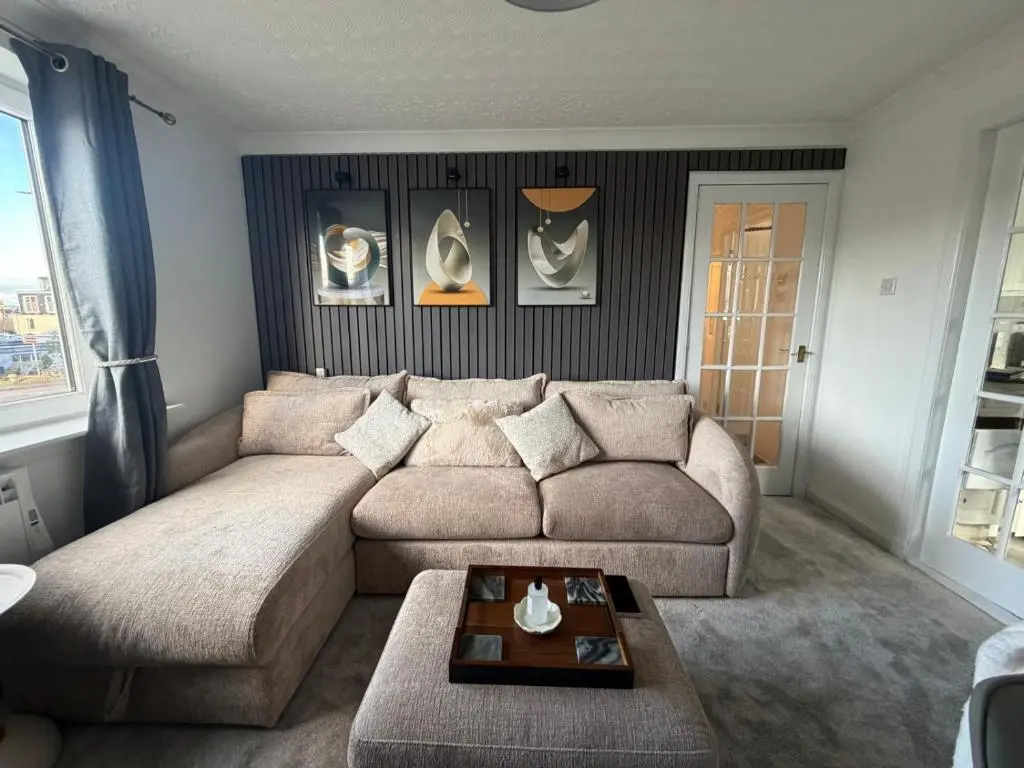a living room with a couch and a table at Nessy5 Apartment in Inverness