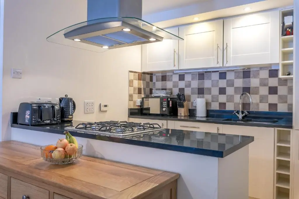 a kitchen with a bowl of fruit on a counter at Torr Apartment Raven in Fort Augustus