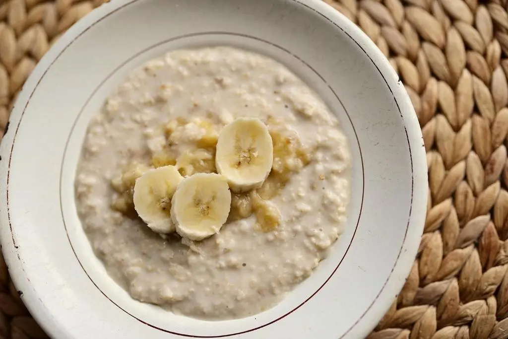 a bowl of oatmeal with bananas in it at Waterside House B&B in Ullapool