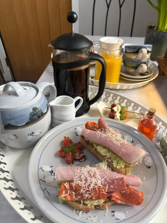 a plate of food with a sandwich on a table at Waterside House B&B in Ullapool