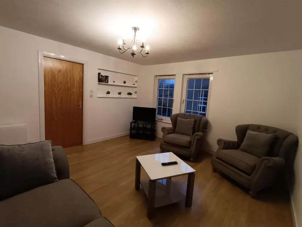 a living room with two chairs and a coffee table at 2 Bed, Banchory in Banchory