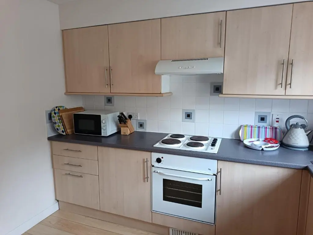 a kitchen with a white stove and a microwave at 2 Bed, Banchory in Banchory