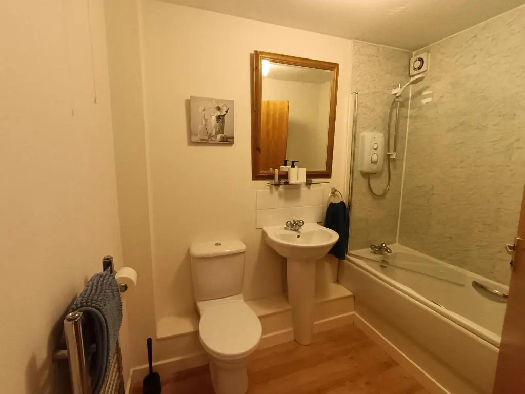 a bathroom with a toilet and a sink and a shower at 2 Bed, Banchory in Banchory