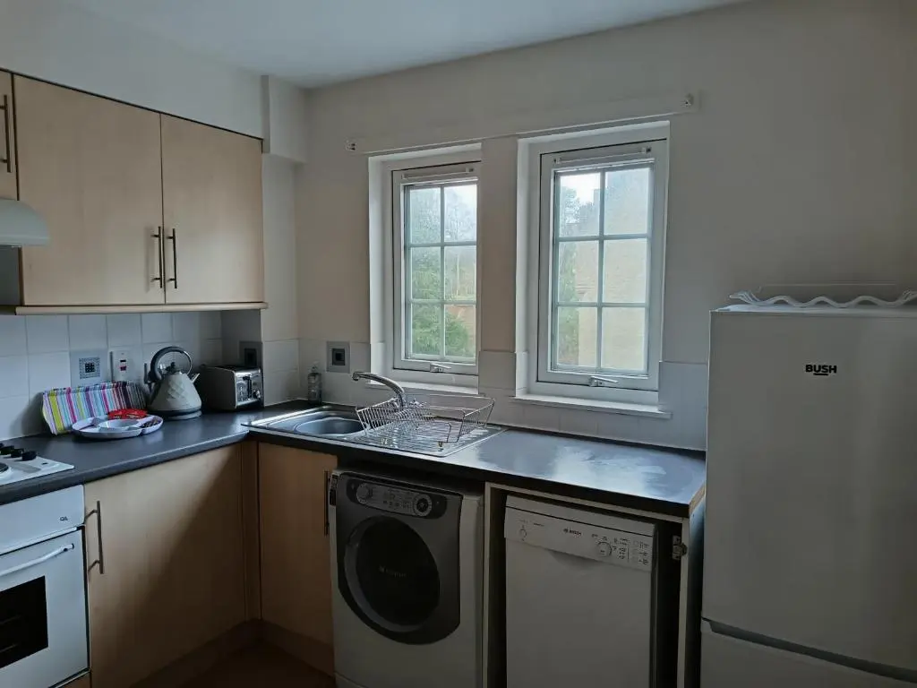 a kitchen with a dishwasher and a washer at 2 Bed, Banchory in Banchory