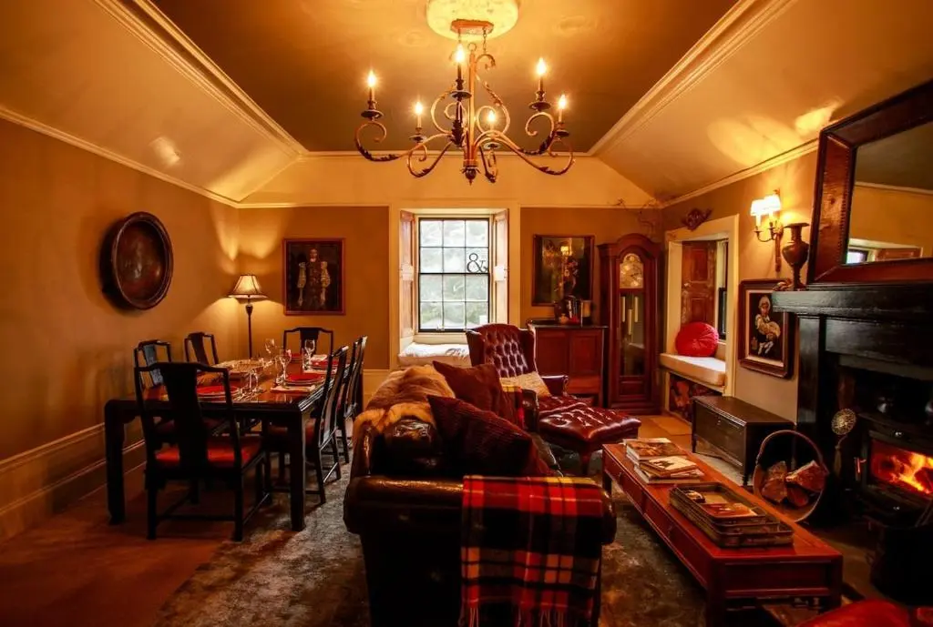 a living room with a couch and a table at Bliss Cottage in Nairn