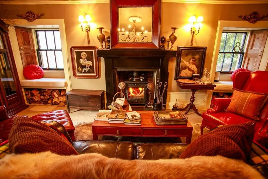 a living room with a couch and a fireplace at Bliss Cottage in Nairn