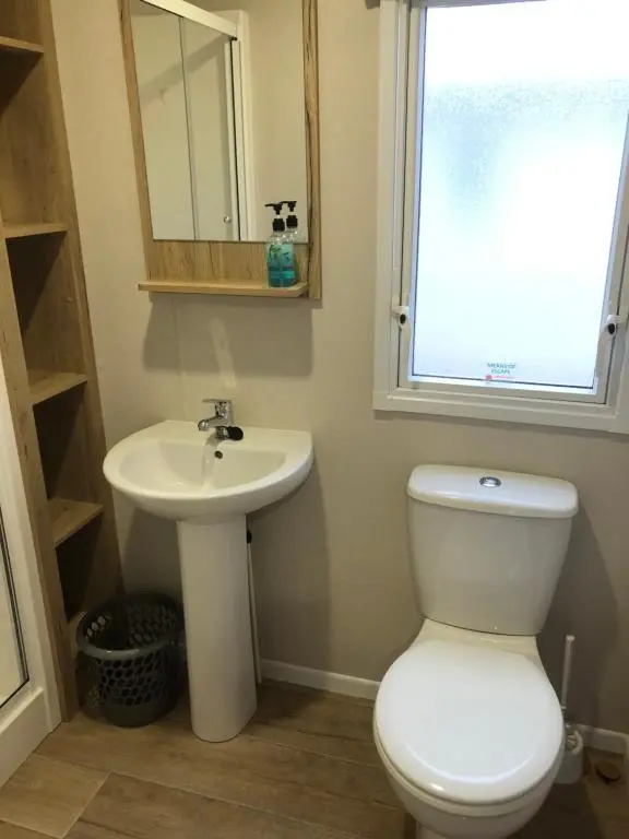 a bathroom with a toilet and a sink at Dunes Escape in Lossiemouth