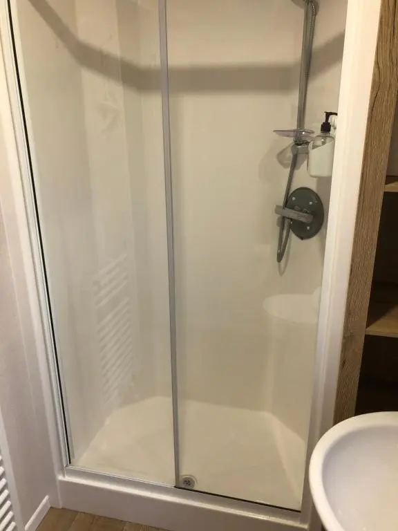 a shower with a glass door in a bathroom at Dunes Escape in Lossiemouth