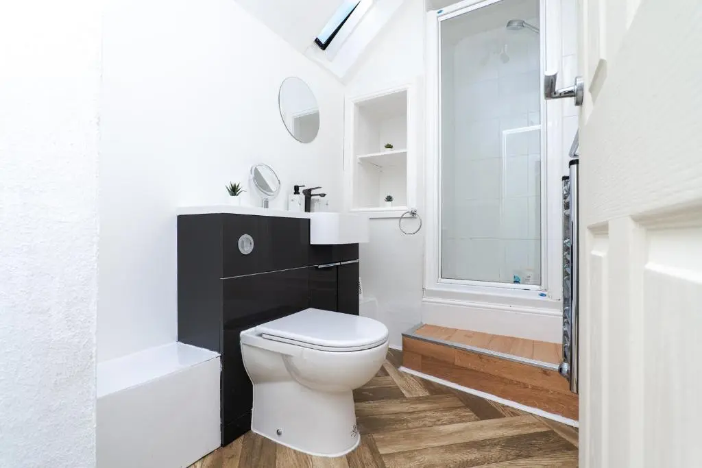 a bathroom with a toilet and a sink and a shower at Charming 1-Bed Coastal Cottage by Holiday Homes in Portgordon