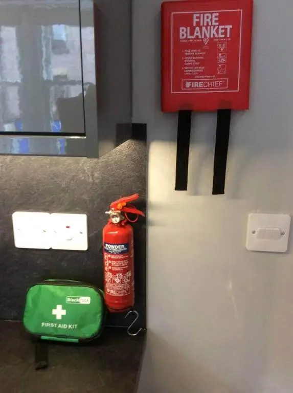 a fire extinguisher is sitting next to a fire extinguisherventory at Macdonald Apartment 11C Greig St Inverness IV3 5PT in Inverness