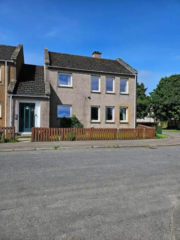 a house with a wooden fence in front of a street at Harbour View 45 Anderson Street Inverness IV3 8BU in Inverness