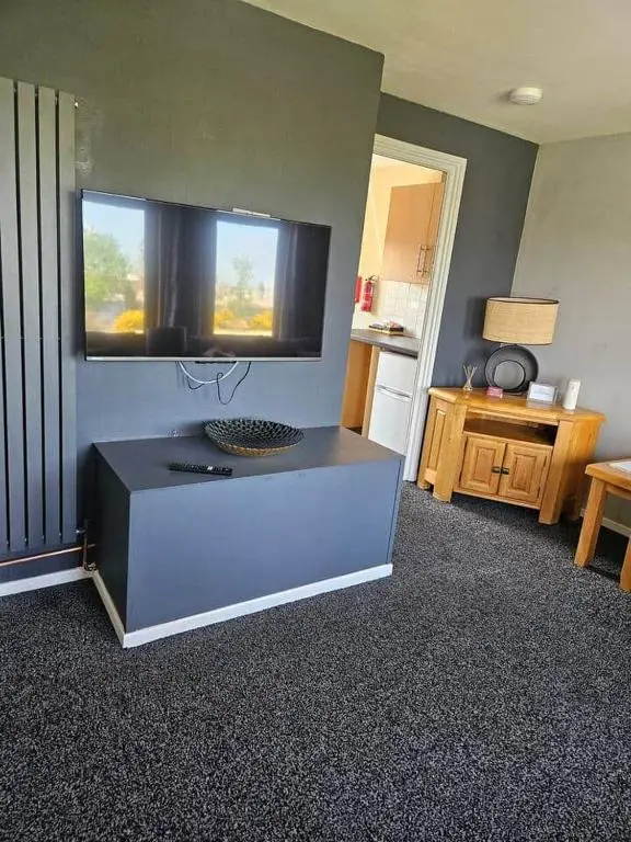a kitchen with a counter with a window and a table at Harbour View 45 Anderson Street Inverness IV3 8BU in Inverness
