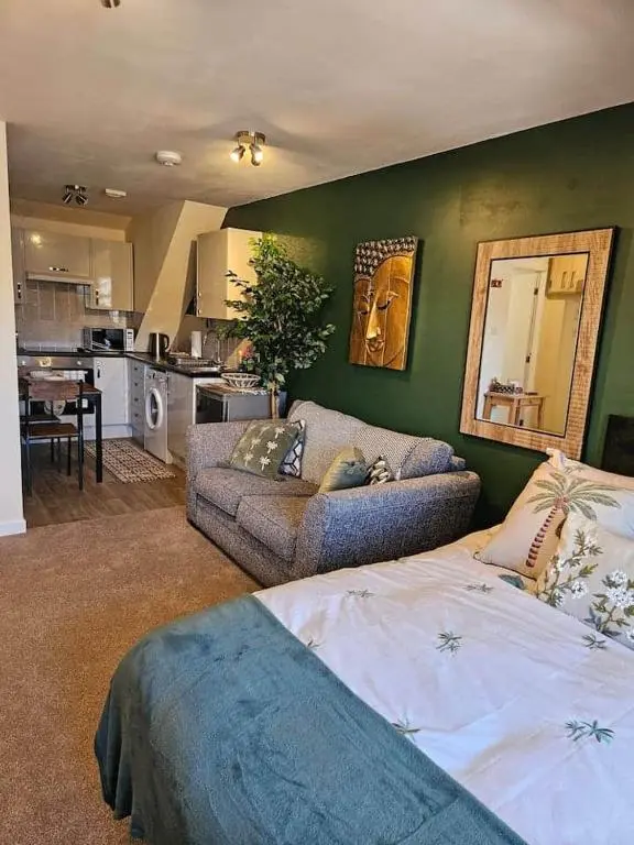 a living room with a bed and a couch at Flat 4 /2 Murray Place Haugh Rd Inverness IV2 4SH in Inverness