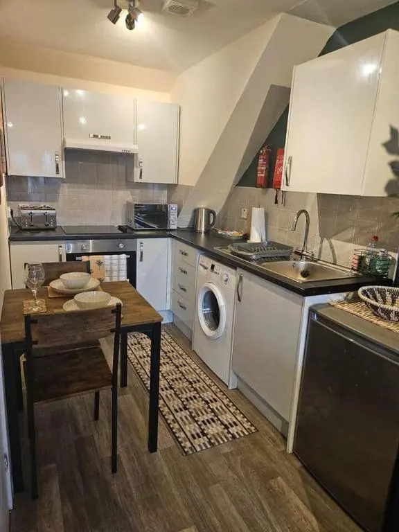 a kitchen with a sink and a washing machine at Flat 4 /2 Murray Place Haugh Rd Inverness IV2 4SH in Inverness