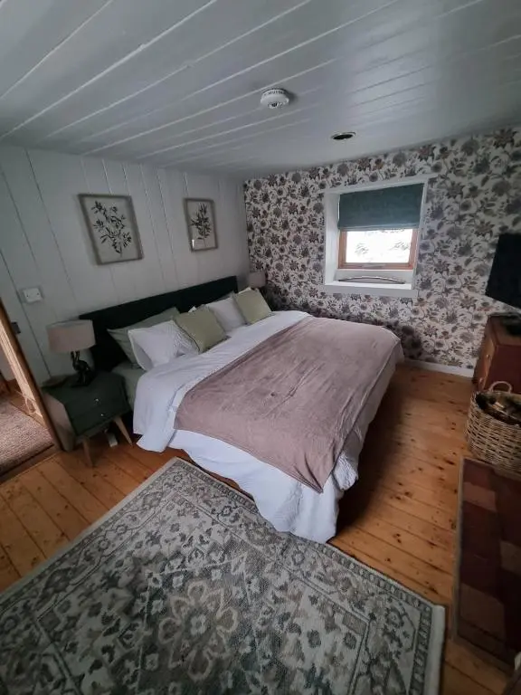 a bedroom with a large bed and a window at bochruben in Inverness