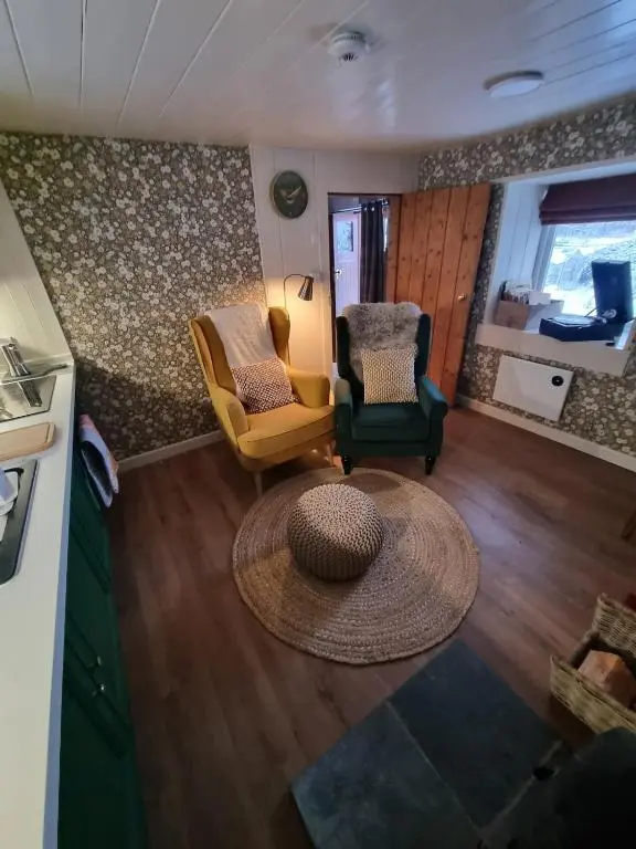 an aerial view of a living room with two chairs and a table at bochruben in Inverness