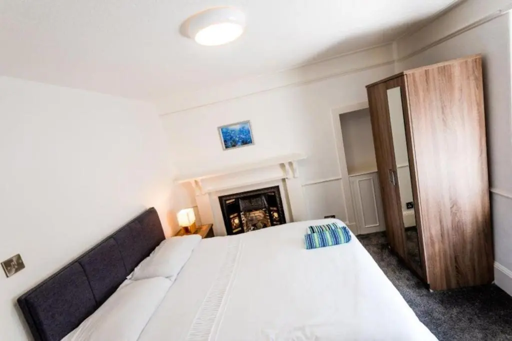 a bedroom with a bed and a fireplace at Josies House in Banff