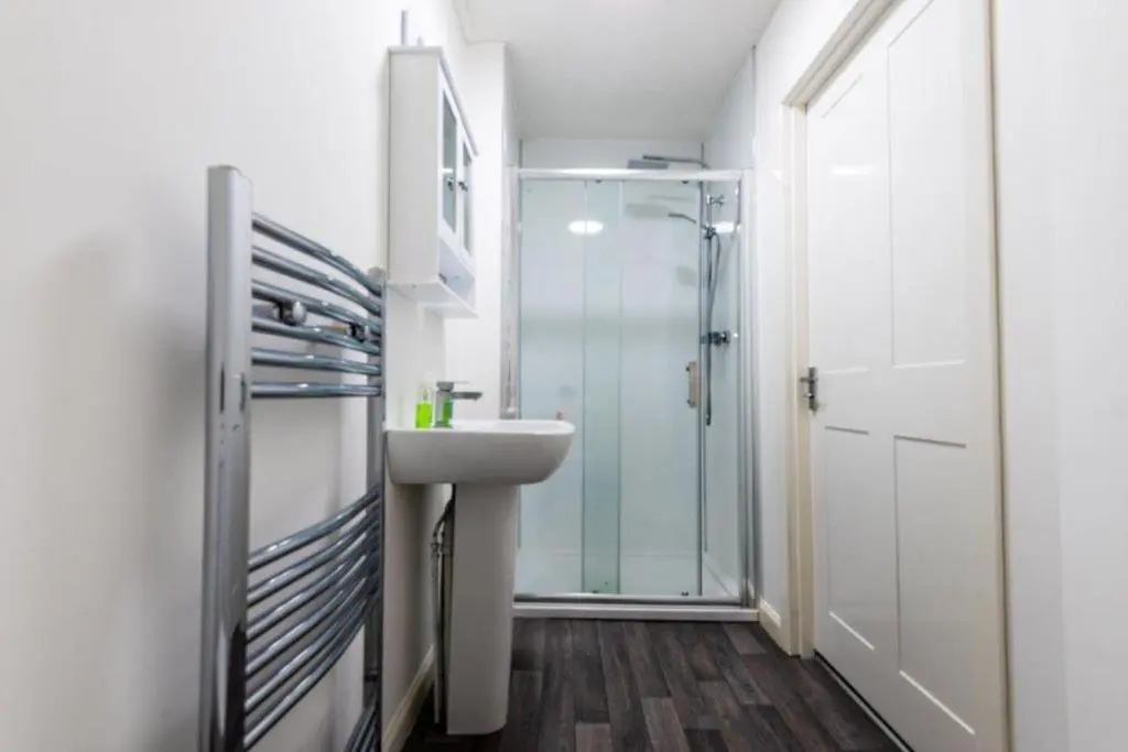 a bathroom with a sink and a glass shower at Josies House in Banff