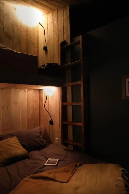 a bedroom with a bunk bed and a ladder at Bespoke Wood Cabin - Loch Ness in Inverfarigaig
