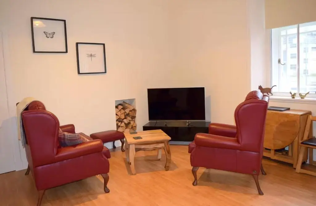 a living room with two chairs and a flat screen tv at Bankside - 1 En-Suite in Central - Free Parking in Wick