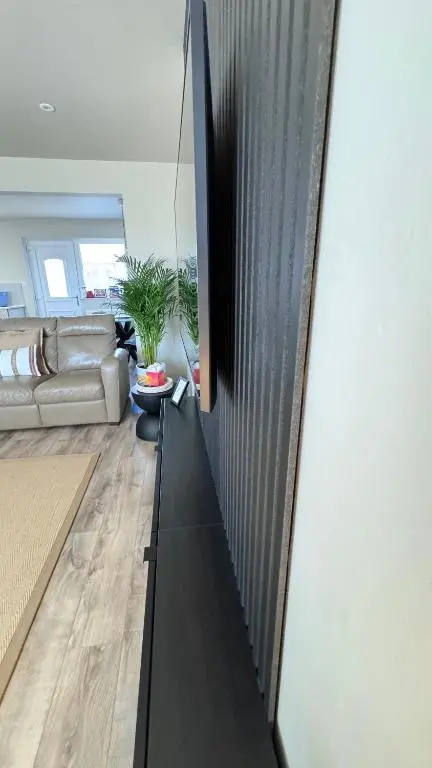 a living room with a black entertainment center at No 67 West Road in Fraserburgh