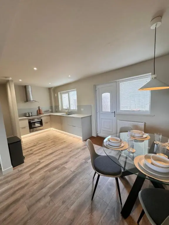 a living room with a table and chairs and a kitchen at No 67 West Road in Fraserburgh