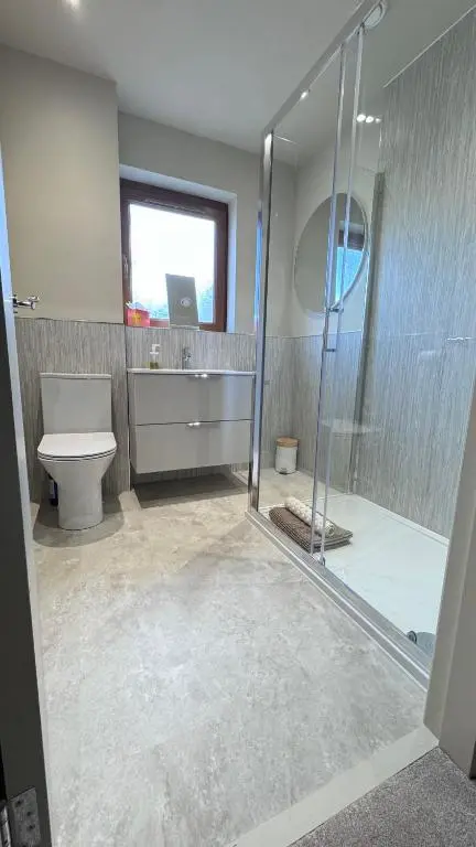 a bathroom with a shower and a toilet and a sink at No 67 West Road in Fraserburgh
