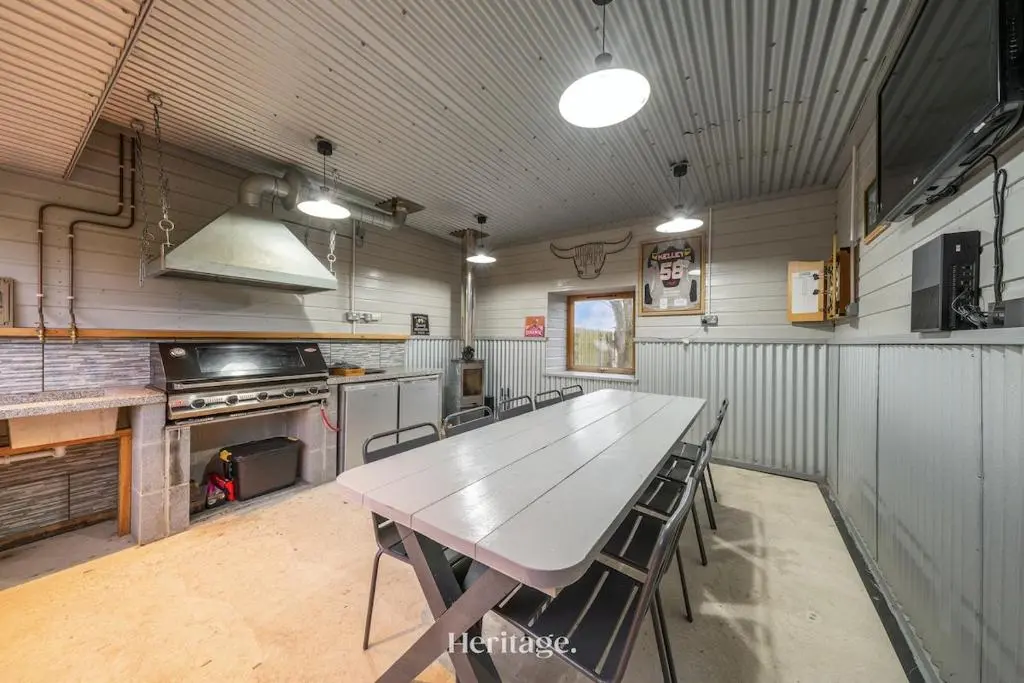 a large kitchen with a table and a stove at The Steading Family Friendly Getaway in Peterhead