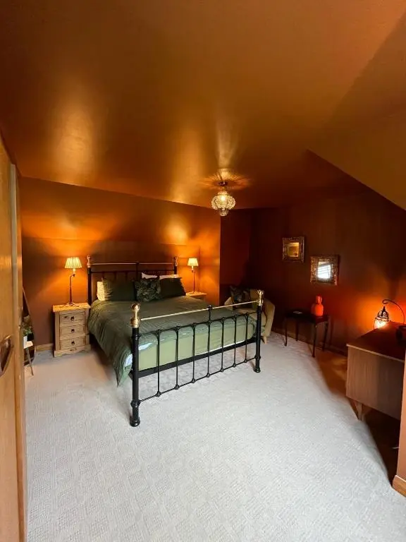 a bedroom with a bed in the corner of a room at Freeburn Lodge - Tomatin in Tomatin