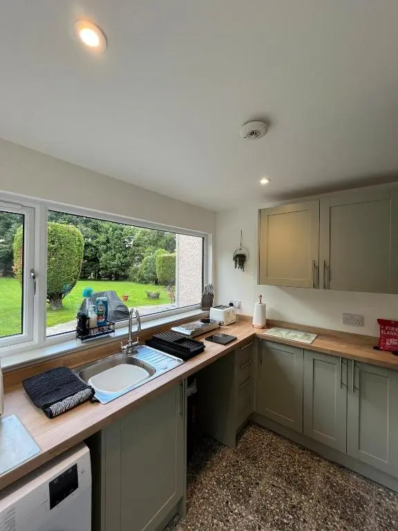 a kitchen with a sink and a window at Freeburn Lodge - Tomatin in Tomatin