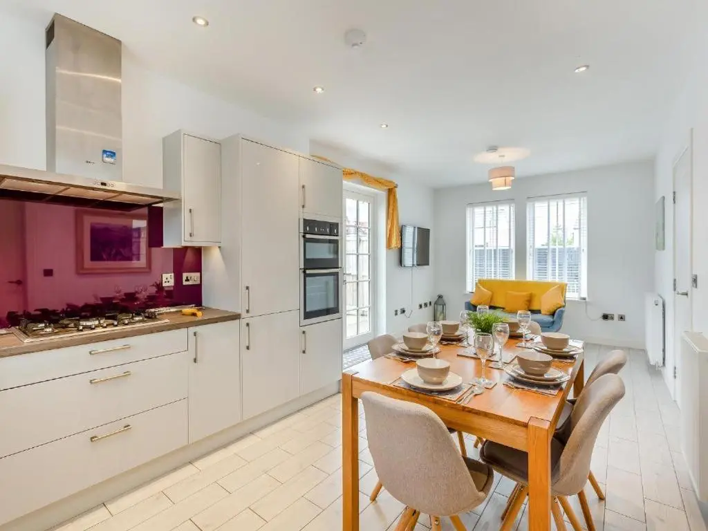 a kitchen with a wooden table and chairs in a room at One The Loan in Inverness
