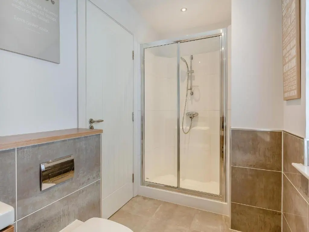 a bathroom with a shower with a glass door at One The Loan in Inverness