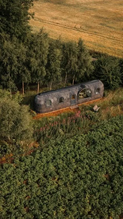 a train is going down the tracks in a field at Boath Cabin in Auldearn