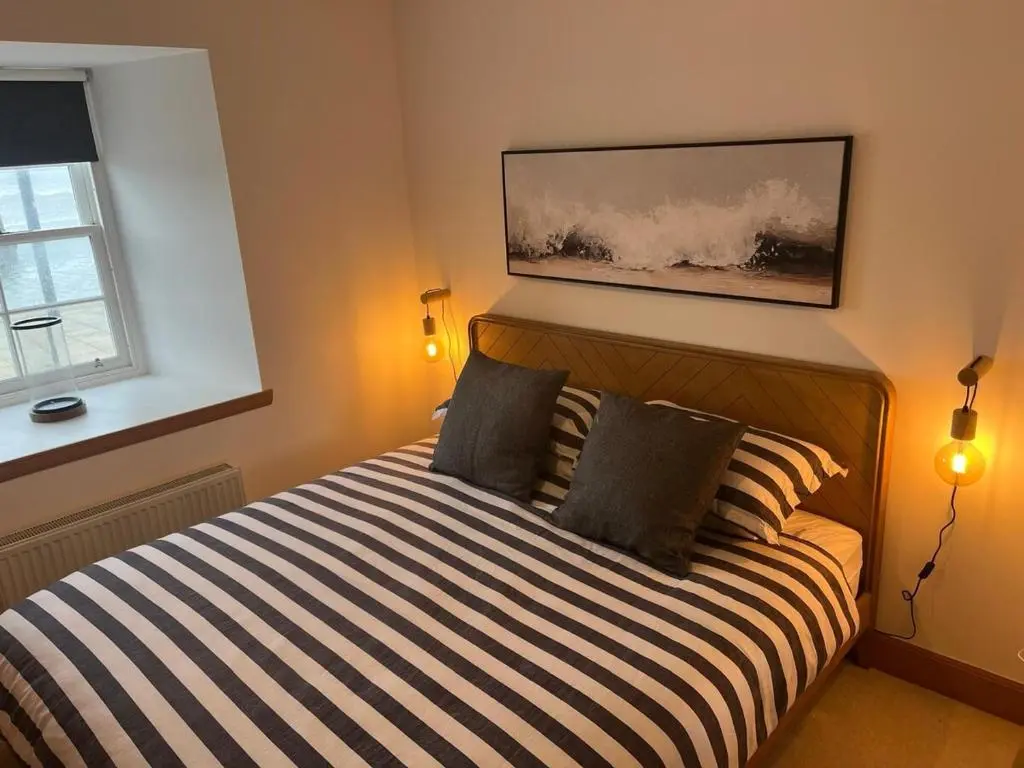 a bedroom with a bed with two pillows at Harbour Haven in Burghead