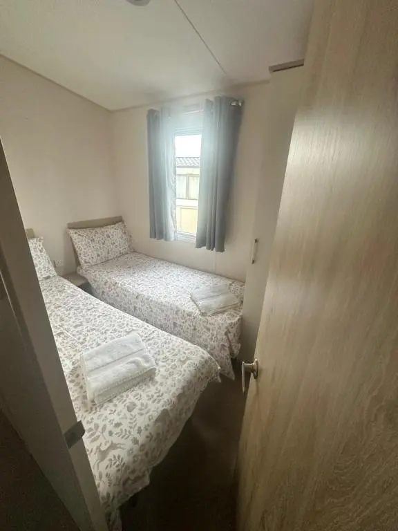 a small room with two beds and a window at Moonstone in Lossiemouth