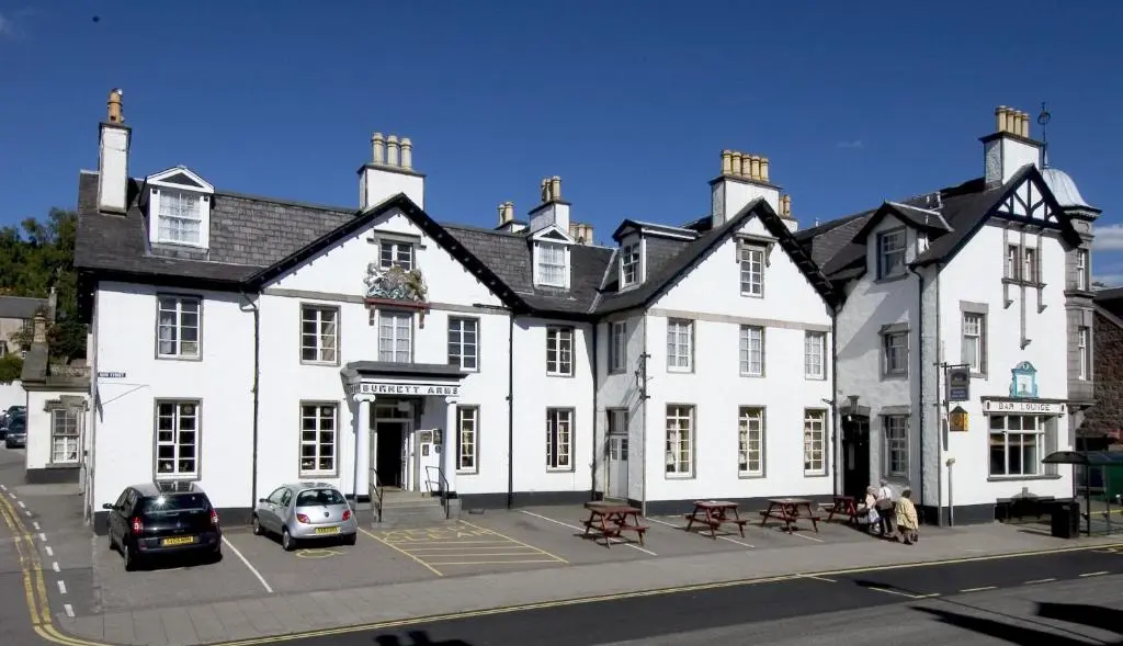 a large white building with cars parked in front of it at Burnett Arms Hotel in Banchory