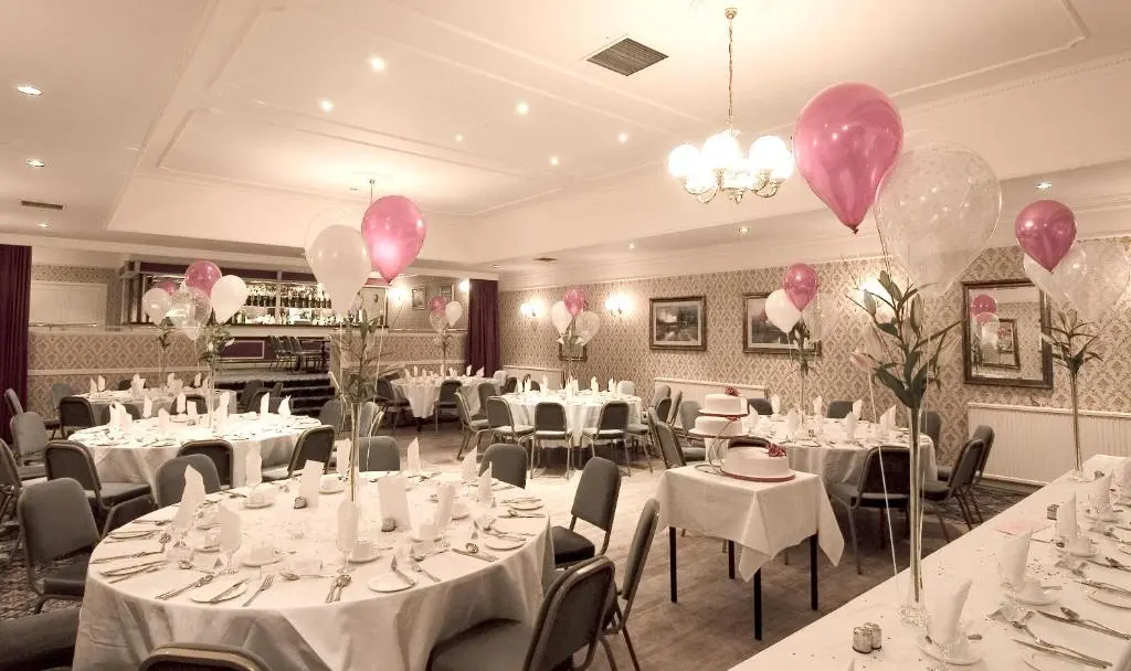 a banquet room with white tables and pink balloons at Burnett Arms Hotel in Banchory
