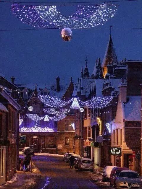 a city street with christmas lights at night at The Royal Hotel Tain in Tain
