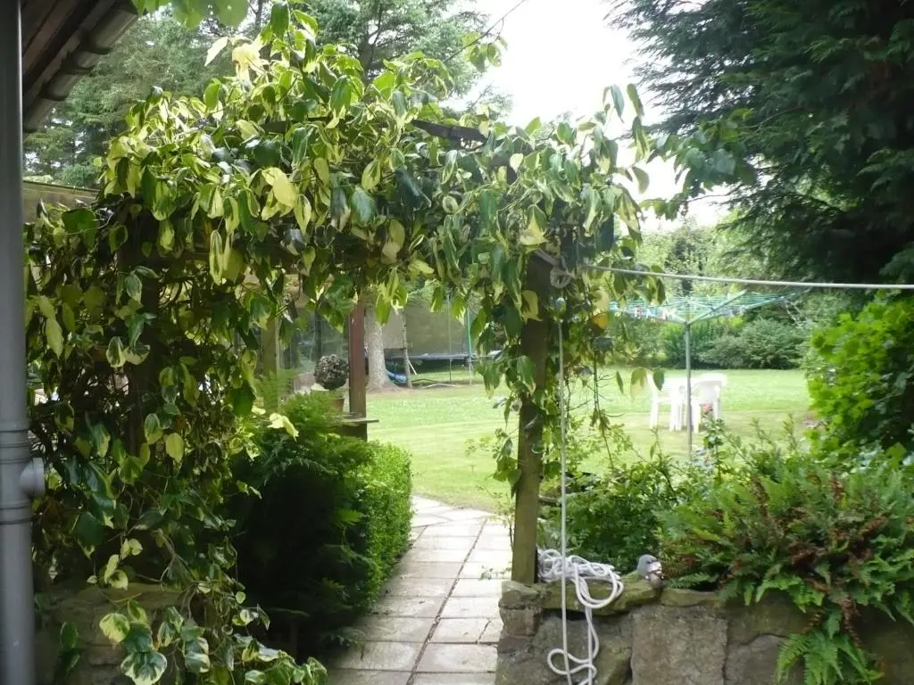 a garden with a pergola in a yard at Hosefield Bed and Breakfast in Ellon